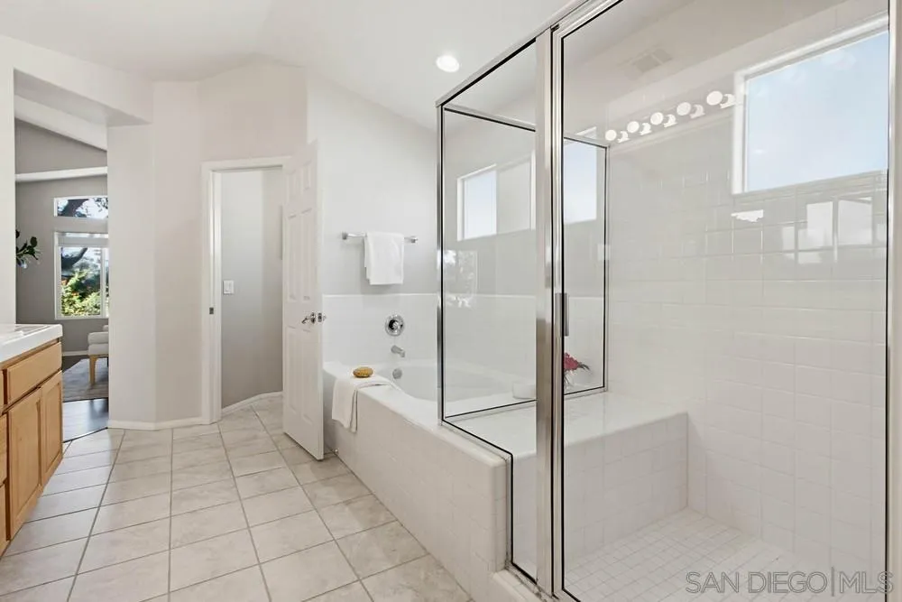 5423 Foxtail Loop Carlsbad, CA 92010 - Photo 35 of 67 a bathroom with a shower and mirror