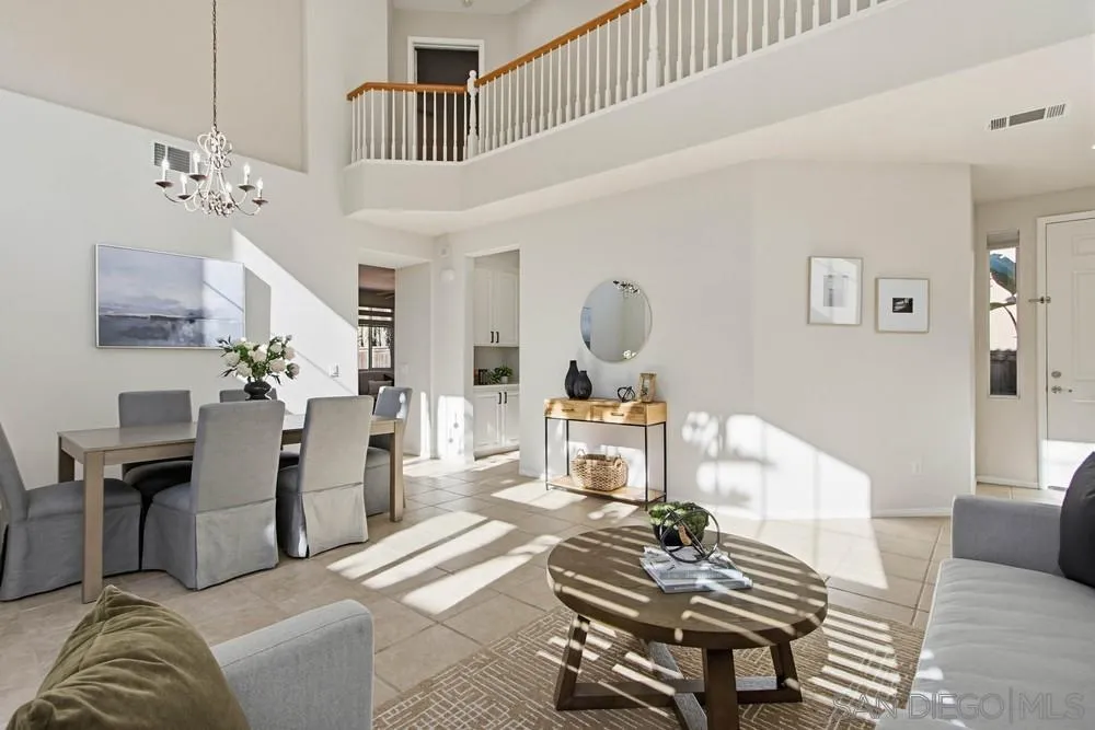 5423 Foxtail Loop Carlsbad, CA 92010 - Photo 4 of 67 a living room with furniture a dining table and paintings on the wall