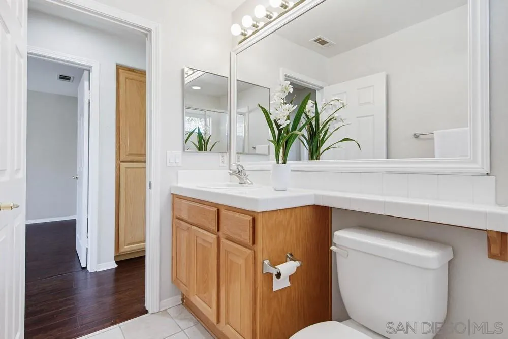 5423 Foxtail Loop Carlsbad, CA 92010 - Photo 43 of 67 a bathroom with a sink a toilet and mirror