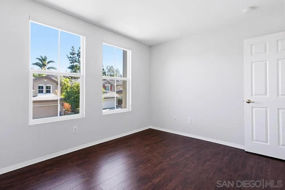 5423 Foxtail Loop Carlsbad, CA 92010 - Photo 45 of 67 a view of an empty room with wooden floor and a window