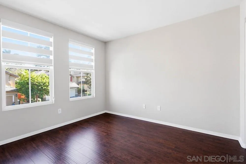 5423 Foxtail Loop Carlsbad, CA 92010 - Photo 47 of 67 an empty room with wooden floor and windows