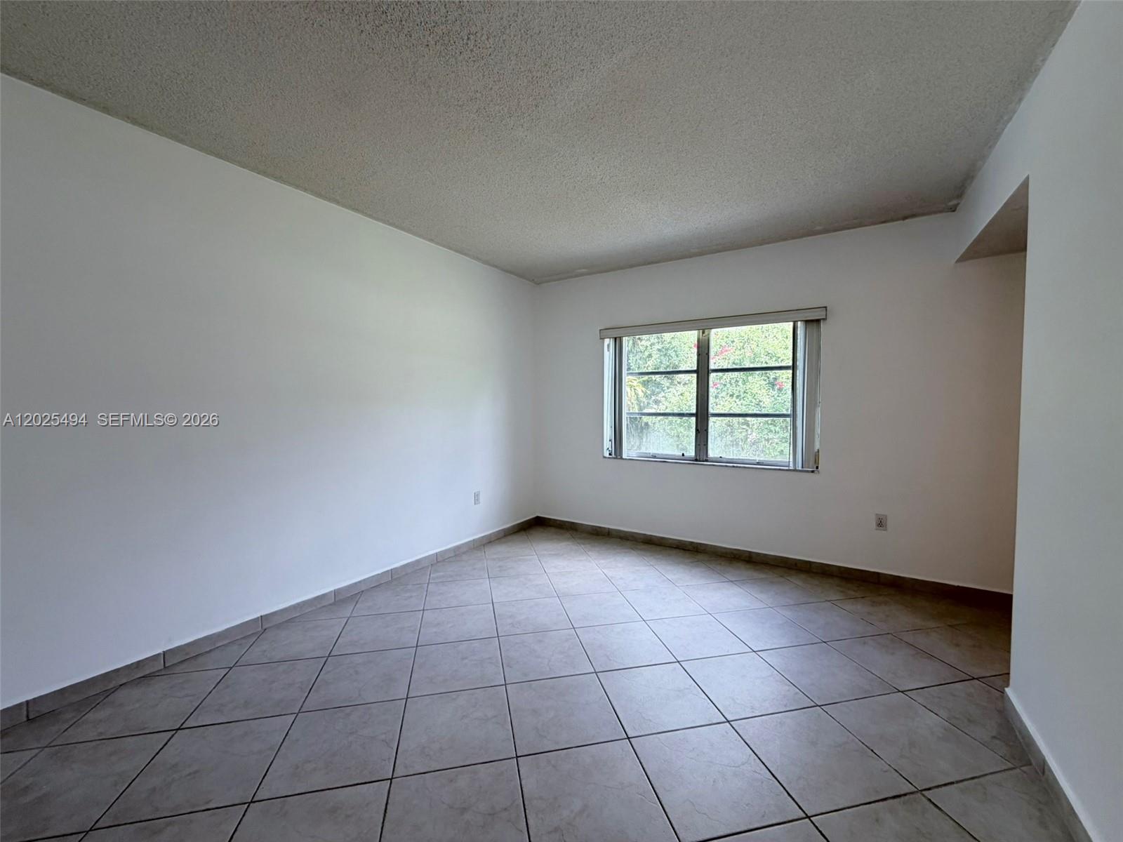 9159 Southwest 77th Avenue, Unit 112 Miami, FL 33156 - Photo 26 of 38 an empty room with windows
