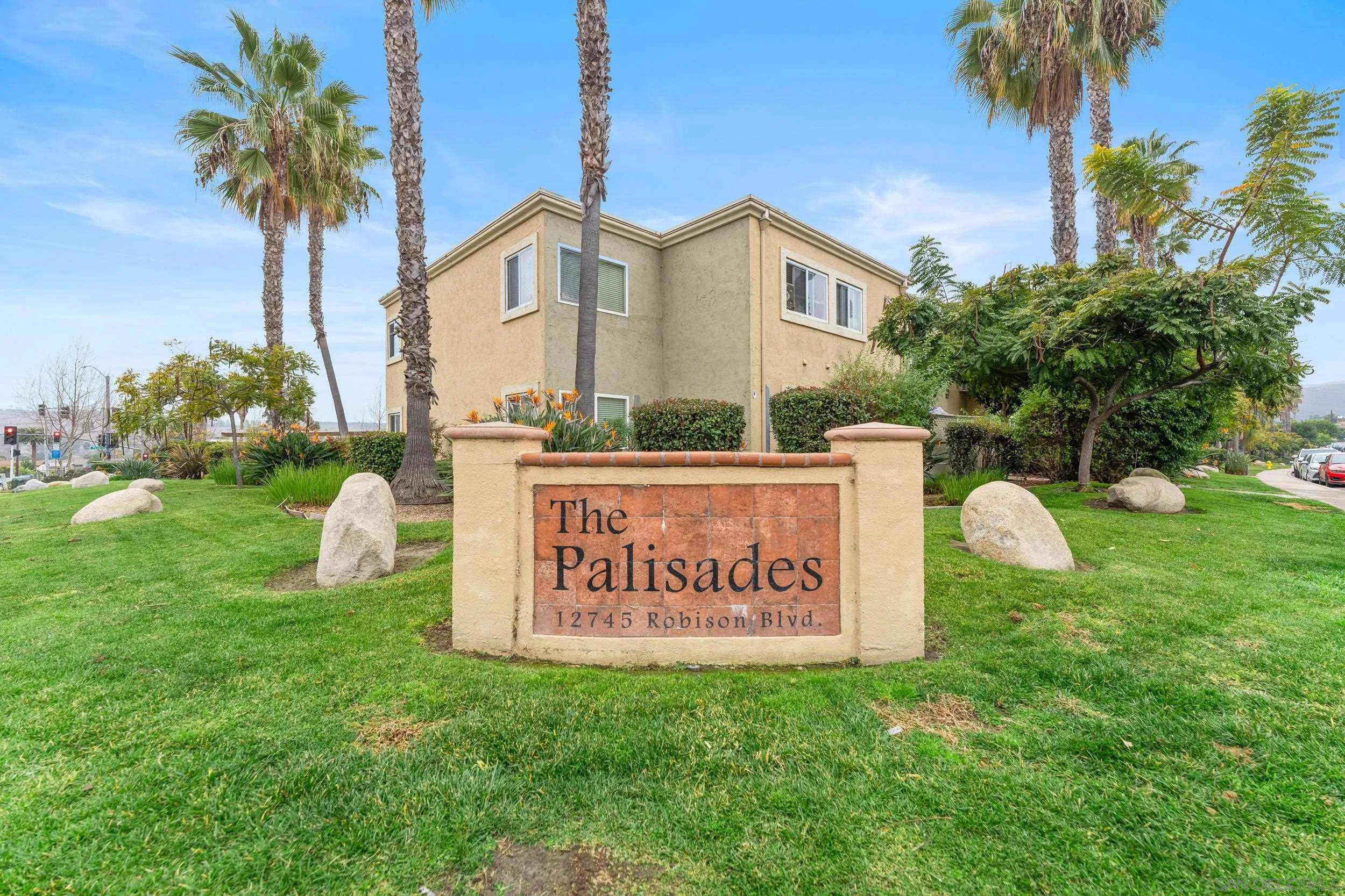 12745 Robison Boulevard Poway, CA 92064 - Photo 1 of 14 a view of a house with a small yard and palm trees
