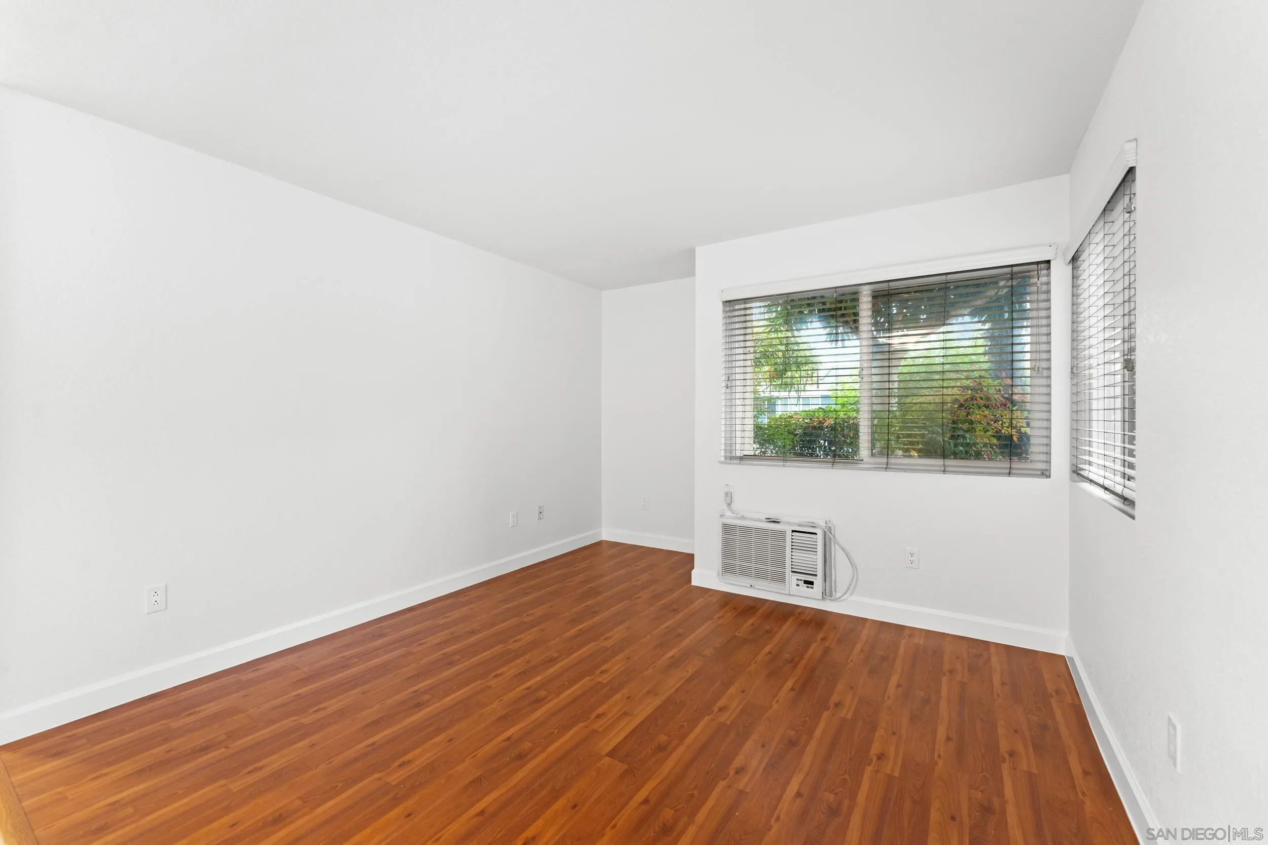 12745 Robison Boulevard Poway, CA 92064 - Photo 5 of 14 an empty room with wooden floor and windows