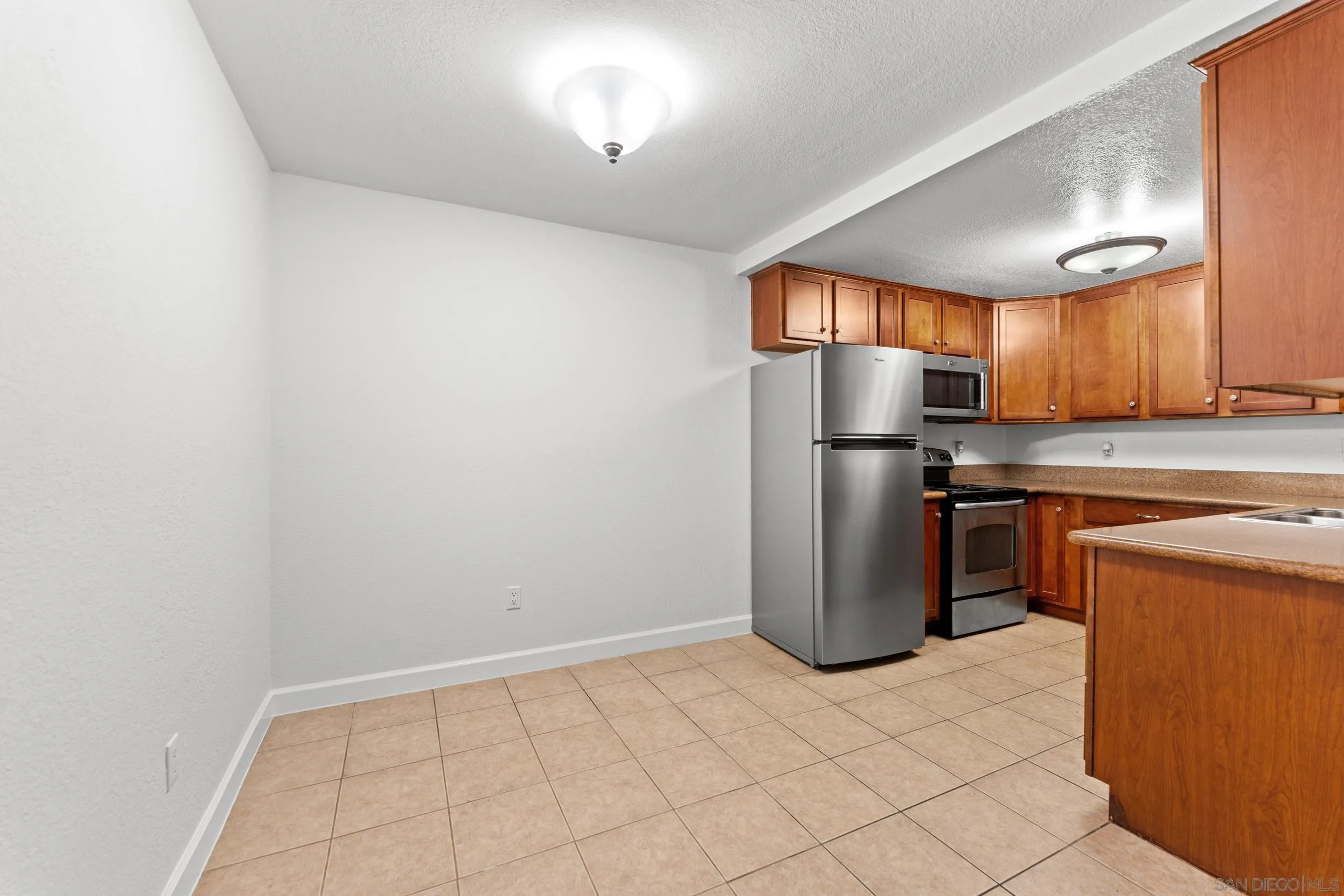 12745 Robison Boulevard Poway, CA 92064 - Photo 6 of 14 a kitchen with a refrigerator and a sink