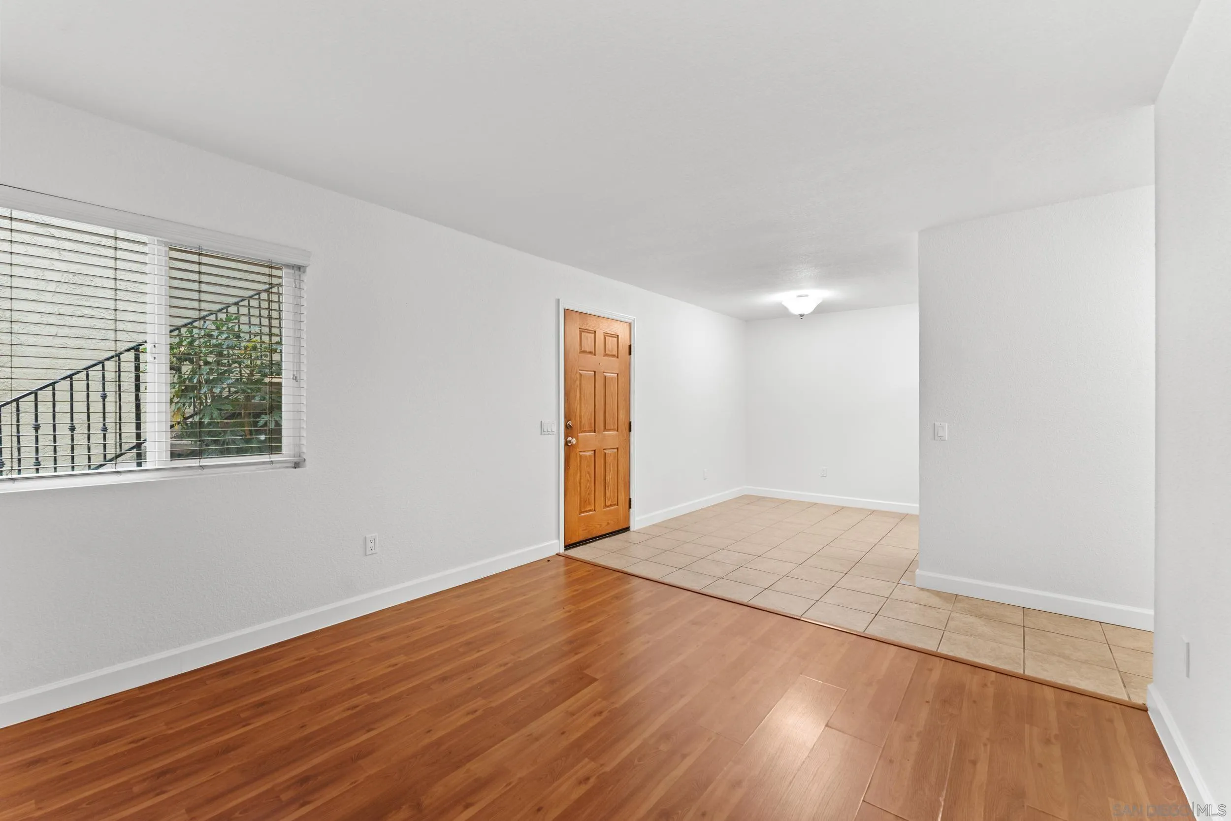 12745 Robison Boulevard Poway, CA 92064 - Photo 7 of 14 a view of an empty room with wooden floor and a window