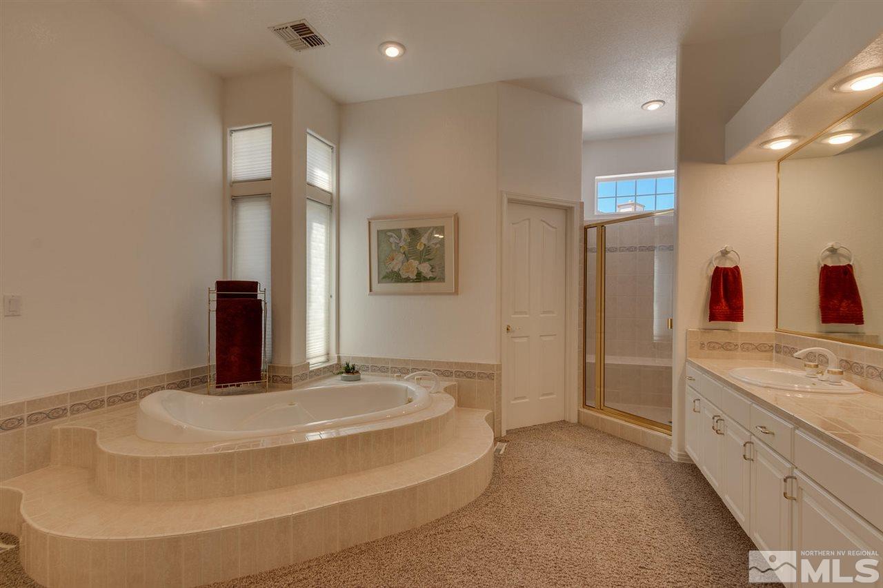 5419 Greenview Court Reno, NV 89502 - Photo 15 of 25 a bathroom with a double vanity sink and a mirror