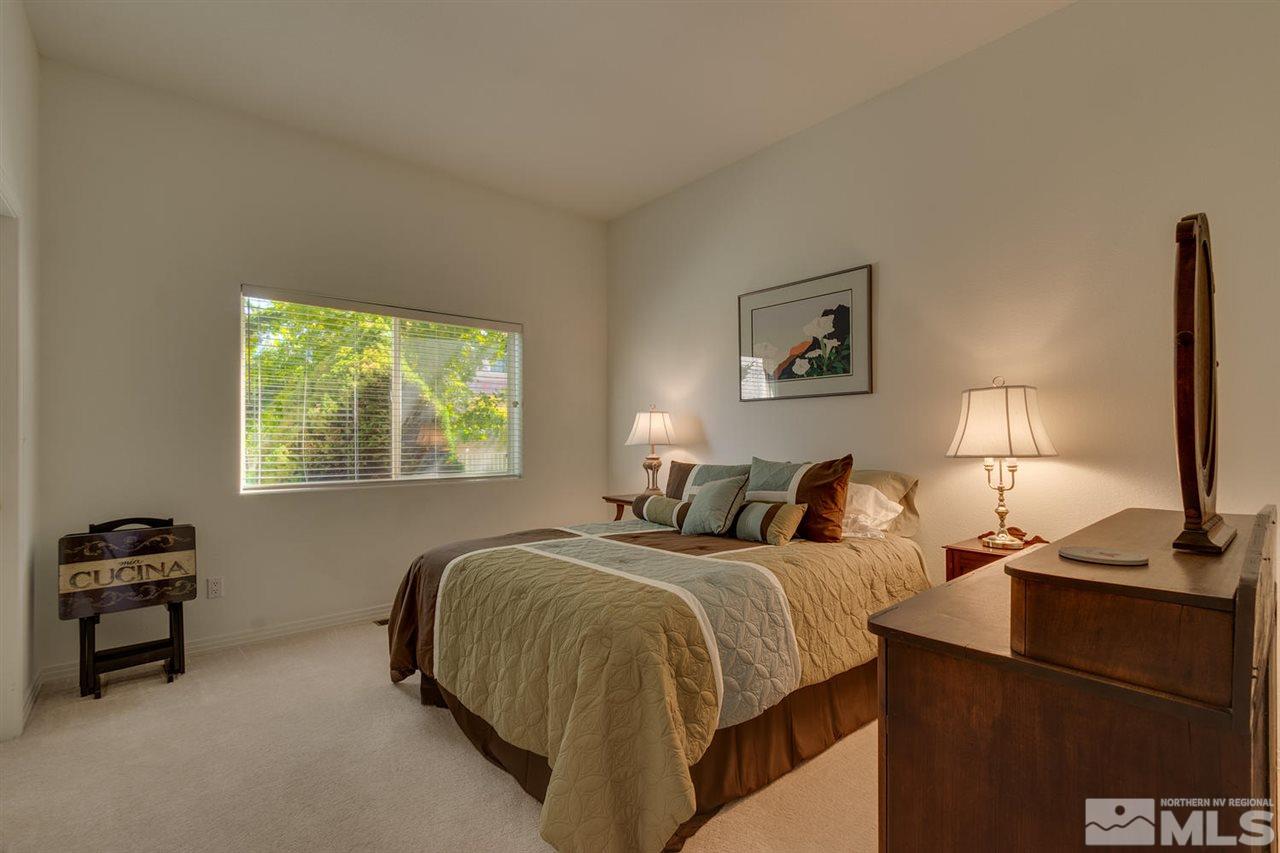 5419 Greenview Court Reno, NV 89502 - Photo 17 of 25 a bedroom with a bed and a lamp