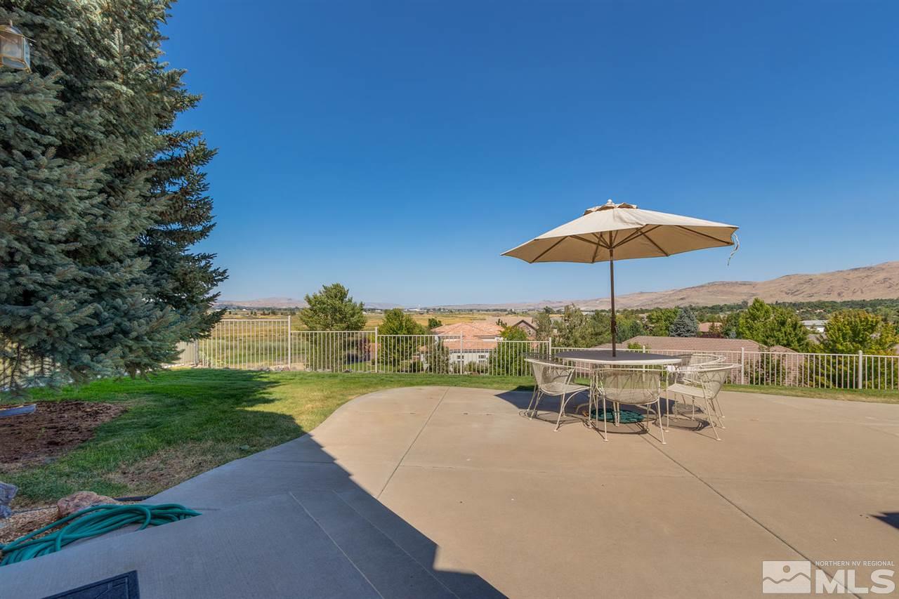 5419 Greenview Court Reno, NV 89502 - Photo 23 of 25 a view of a patio with a table and chairs under an umbrella