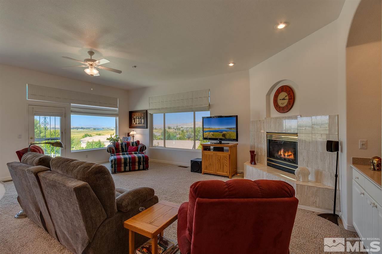 5419 Greenview Court Reno, NV 89502 - Photo 7 of 25 a living room with furniture a fireplace and a flat screen tv
