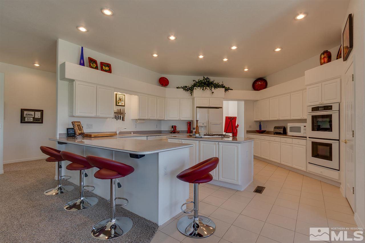 5419 Greenview Court Reno, NV 89502 - Photo 9 of 25 a kitchen with stainless steel appliances kitchen island granite countertop a sink and cabinets