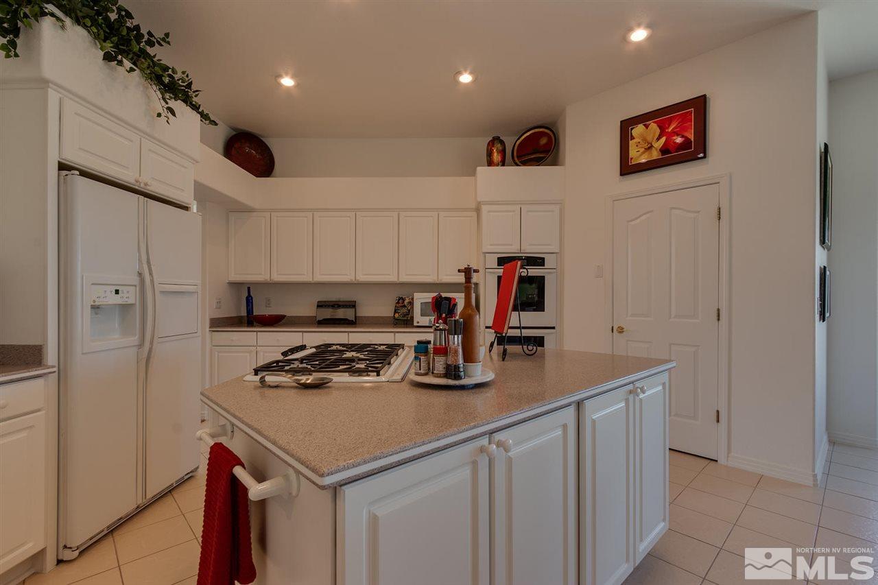 5419 Greenview Court Reno, NV 89502 - Photo 10 of 25 a kitchen with stainless steel appliances granite countertop a stove and a refrigerator