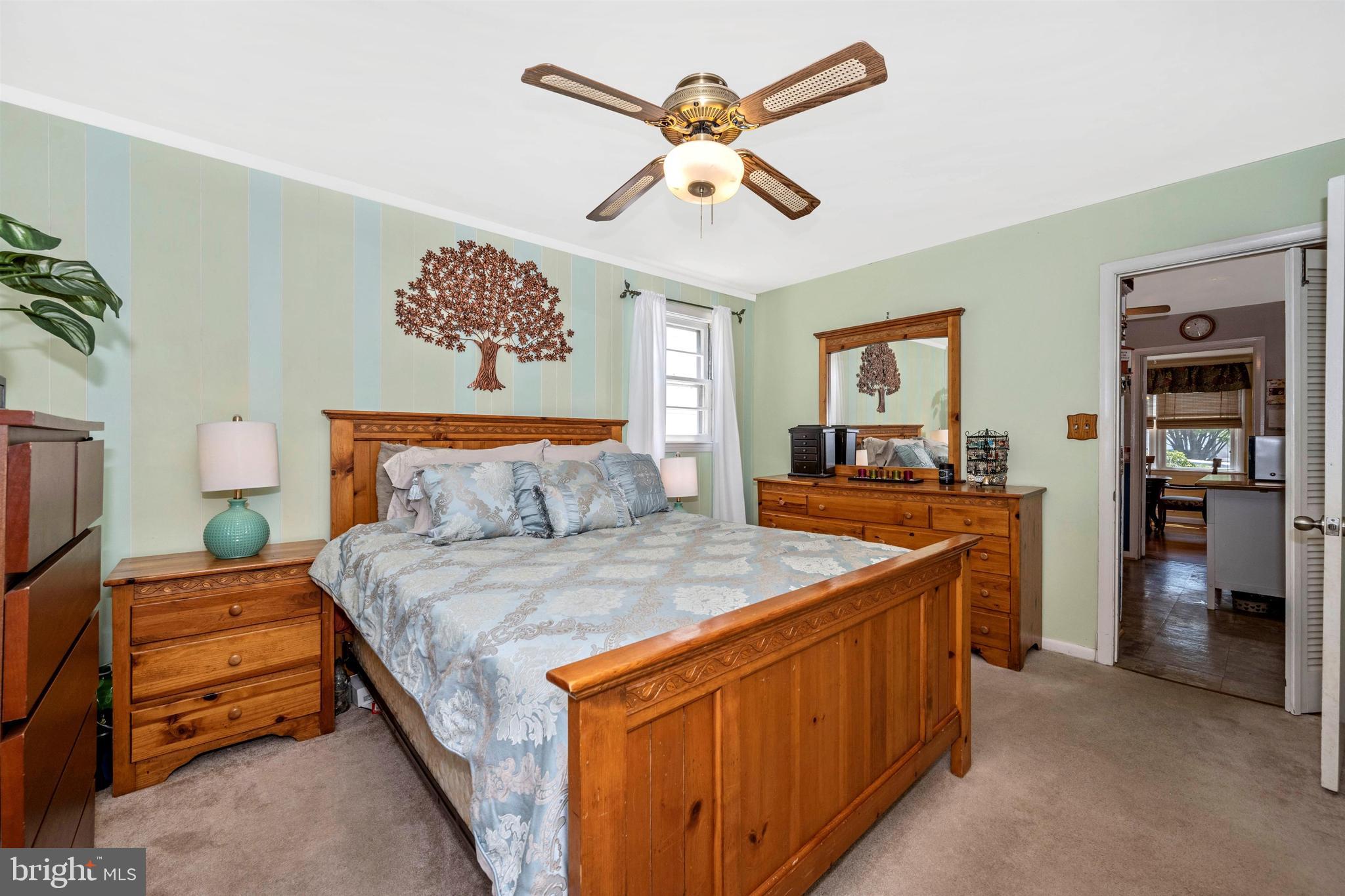 4304 Ridge Avenue Baltimore, MD 21227 - Photo 18 of 50 a bedroom with a bed and a chandelier