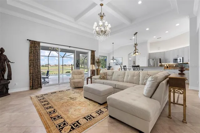 a living room with furniture and a chandelier