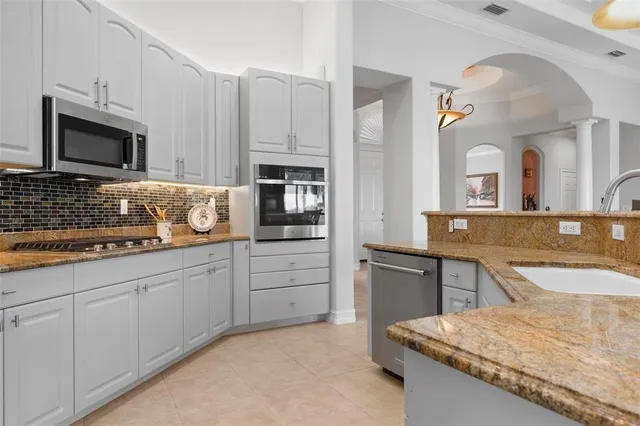 a living room with furniture and a potted plant with wooden floor