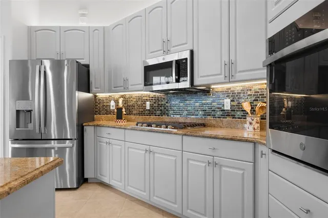 a spacious bathroom with a granite countertop tub sink shower and mirror