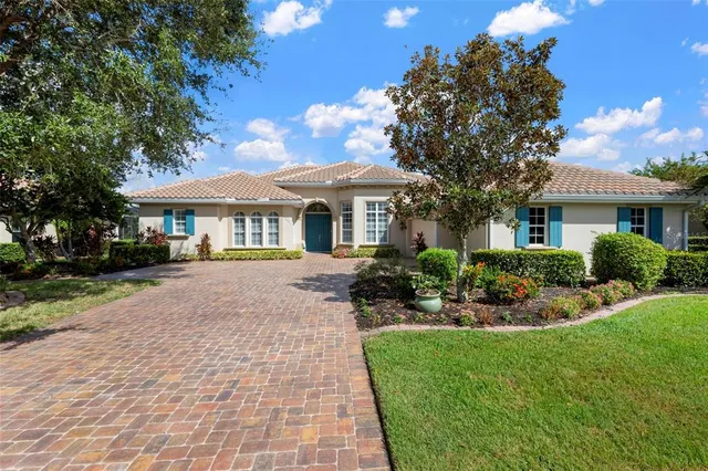 a front view of a house with yard patio and green space