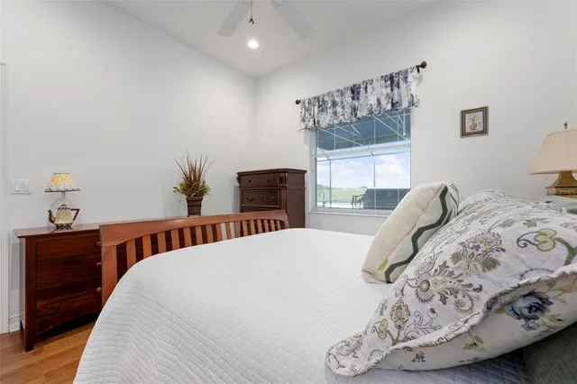 a view of a swimming pool with a patio and a yard