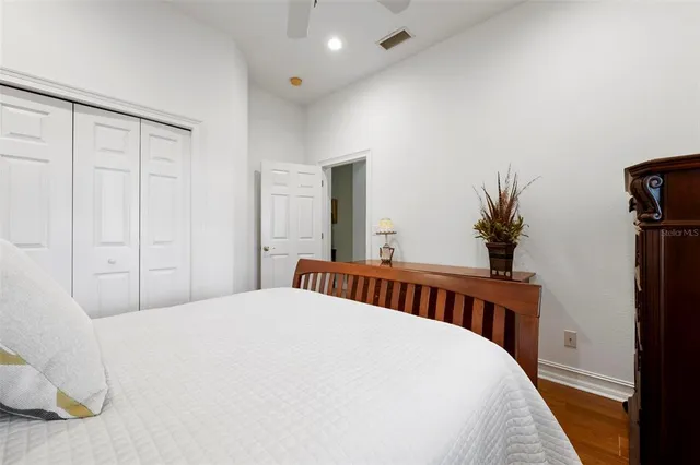 a view of a patio with chairs and table under an umbrella