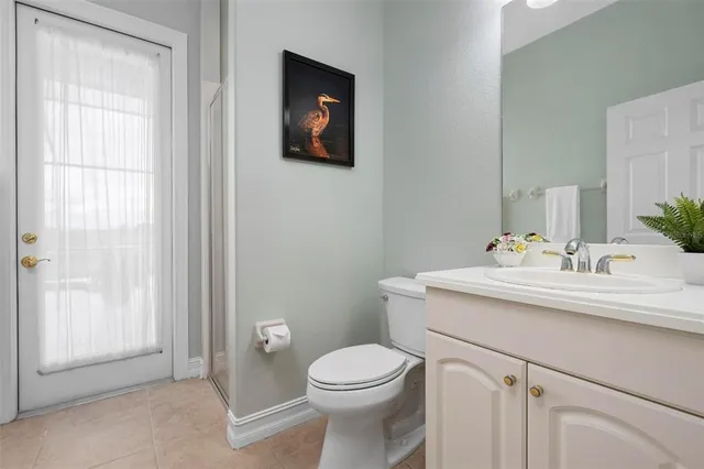 an aerial view of a city with lots of residential buildings ocean and mountain view in back