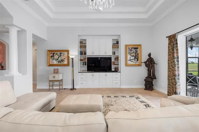 a living room with furniture and a chandelier