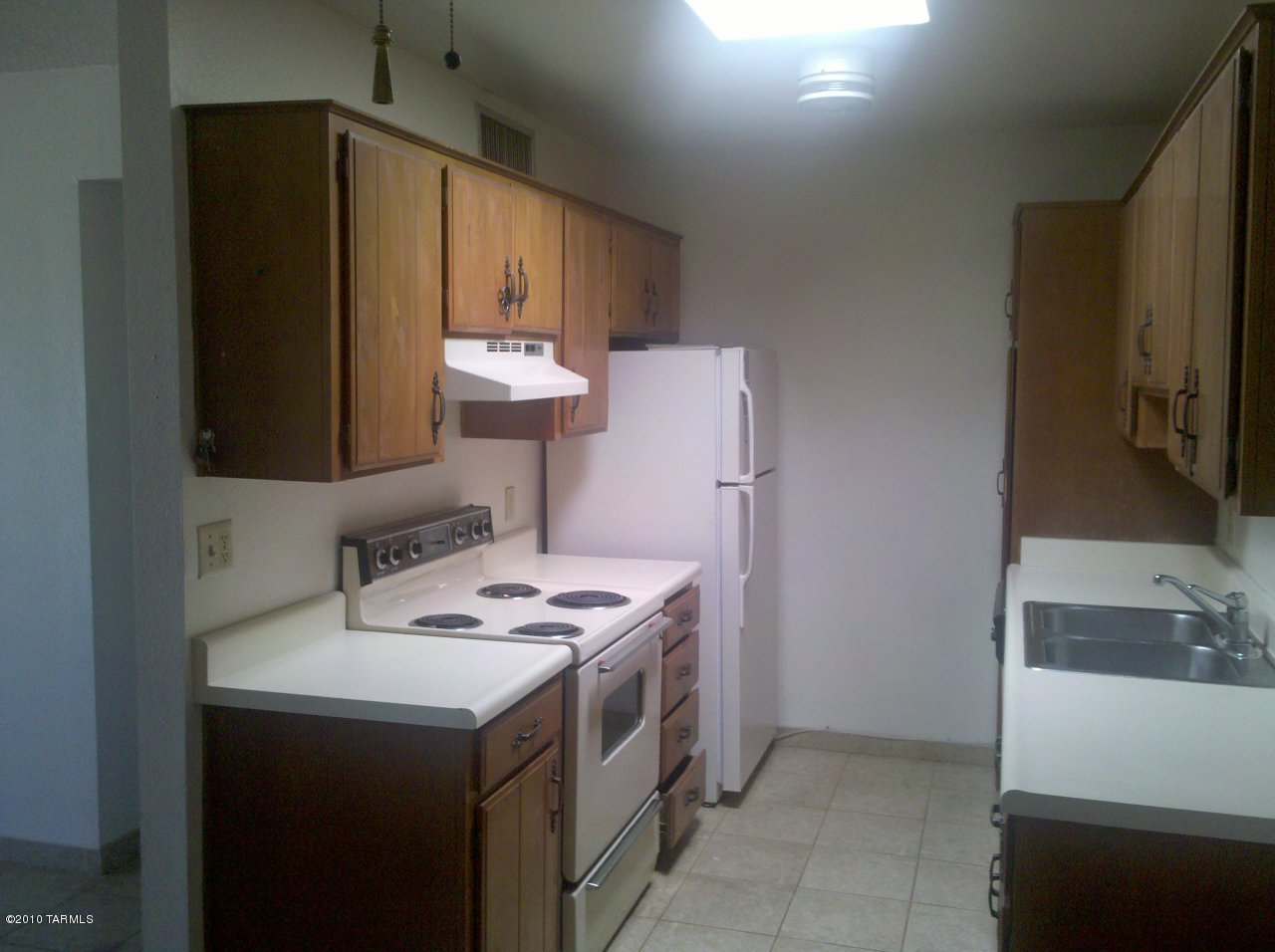 6615 East Golf Links Road, Unit 9 Tucson, AZ 85730 - Photo 1 of 6 a kitchen with stainless steel appliances a stove a refrigerator and a sink