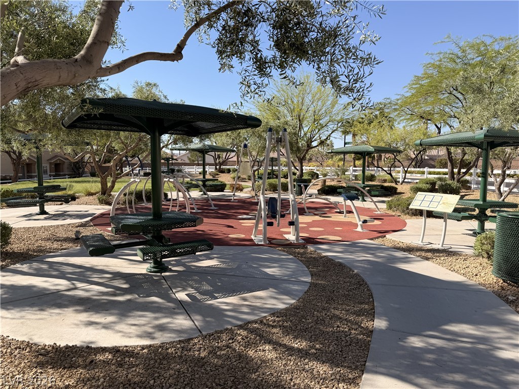 8909 Houston Ridge Avenue Las Vegas, NV 89178 - Photo 48 of 50 A vibrant community recreation area with multiple shaded seating zones and playful ground coverings.
