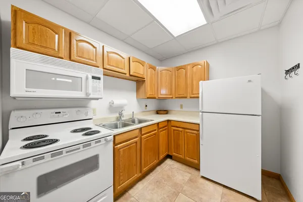 a kitchen with a white cabinets and white appliances