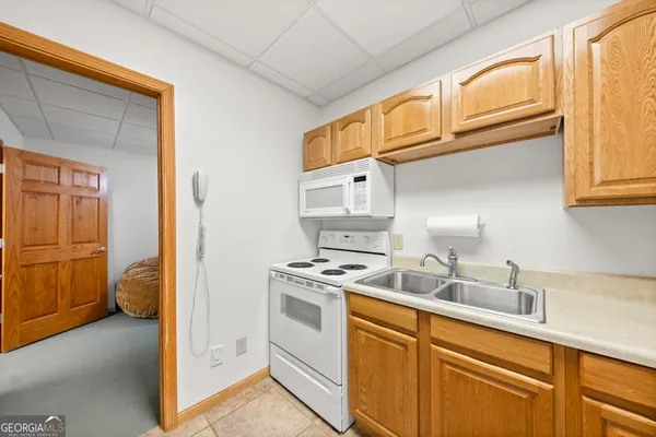 a kitchen with stainless steel appliances granite countertop a sink and cabinets with wooden floor