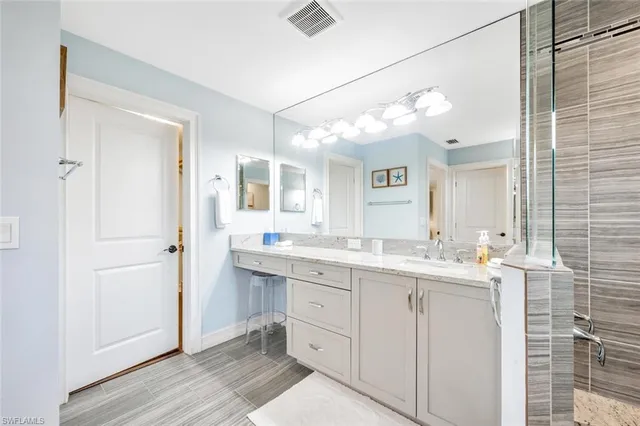 a bathroom with a double vanity sink and mirror