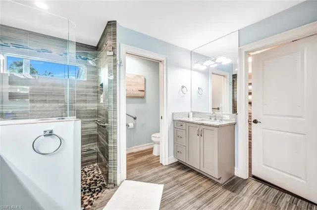 a bathroom with a shower sink and mirror