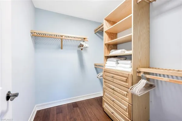 a view of walk in closet with empty racks