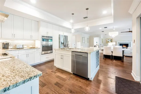 a kitchen with a sink window and cabinets