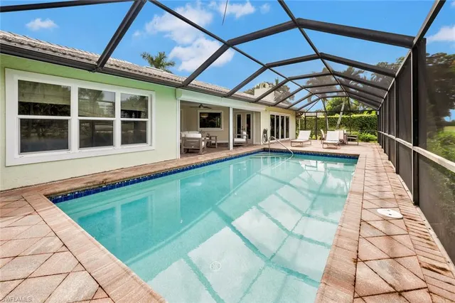 a view of swimming pool with outdoor seating