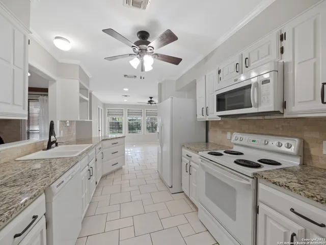 a kitchen with stainless steel appliances granite countertop a sink and cabinets
