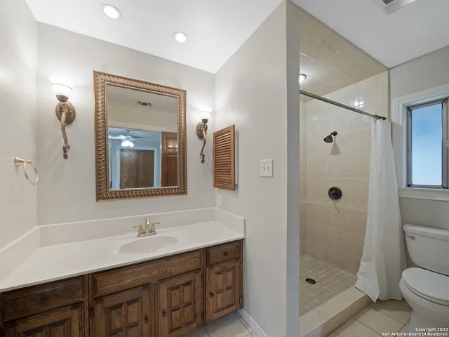 a bathroom with a toilet and shower