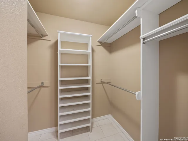 an empty room with a ceiling fan and a window