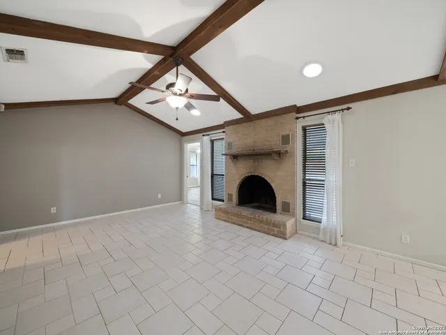 a view of a livingroom with a fireplace and a chandelier