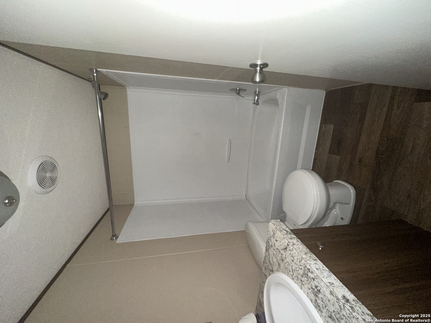 101 Villa Ridge Drive, Unit 6 Poteet, TX 78065 - Photo 13 of 14 a bathroom with a granite countertop sink mirror vanity and toilet