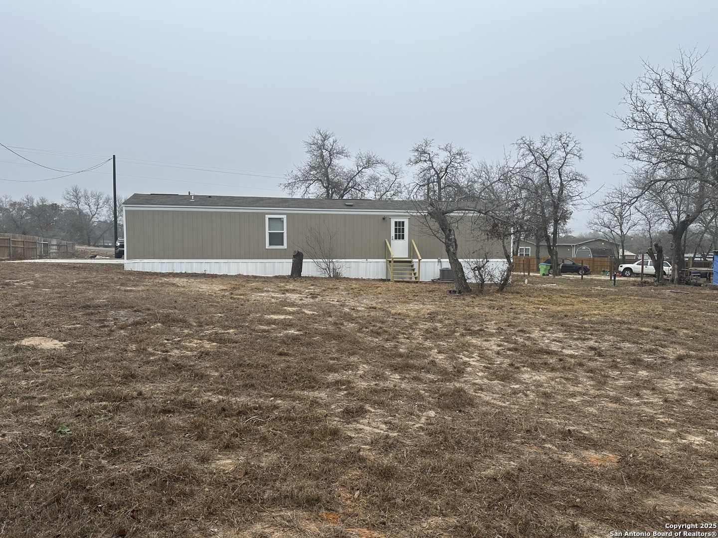101 Villa Ridge Drive, Unit 6 Poteet, TX 78065 - Photo 14 of 14 a view of a house with a yard