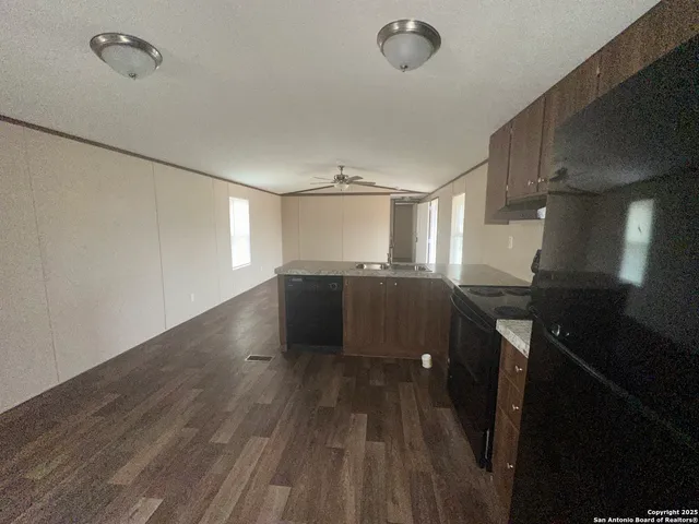 a view of a room with wooden floor