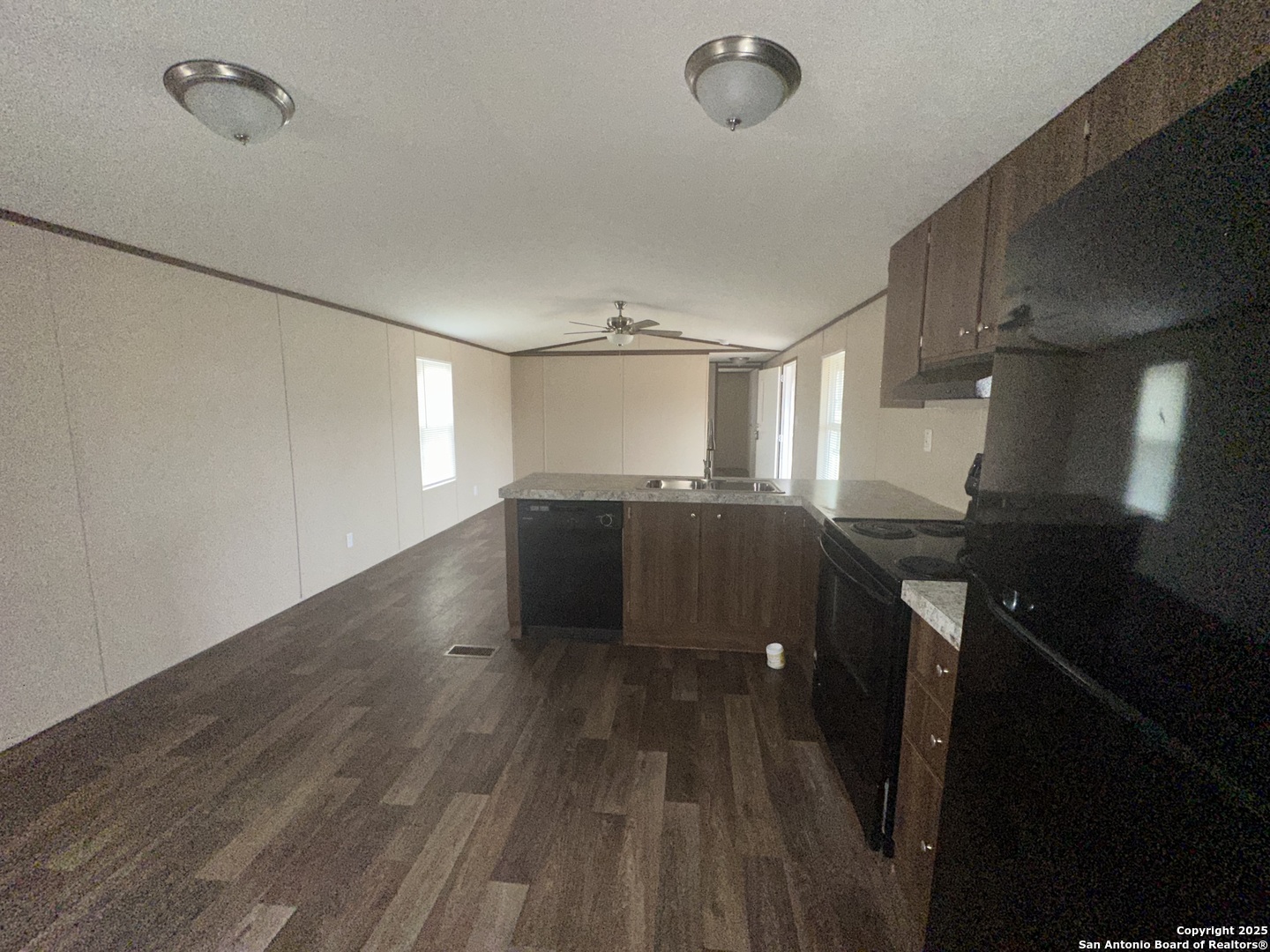101 Villa Ridge Drive, Unit 6 Poteet, TX 78065 - Photo 3 of 14 a kitchen with a sink and wooden floor