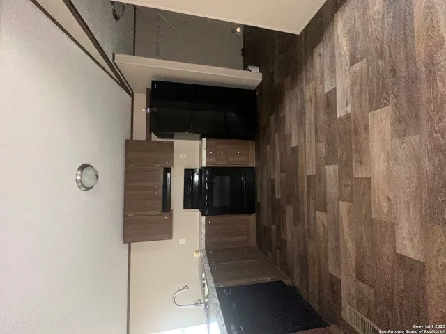 a kitchen with stainless steel appliances granite countertop a refrigerator and a stove