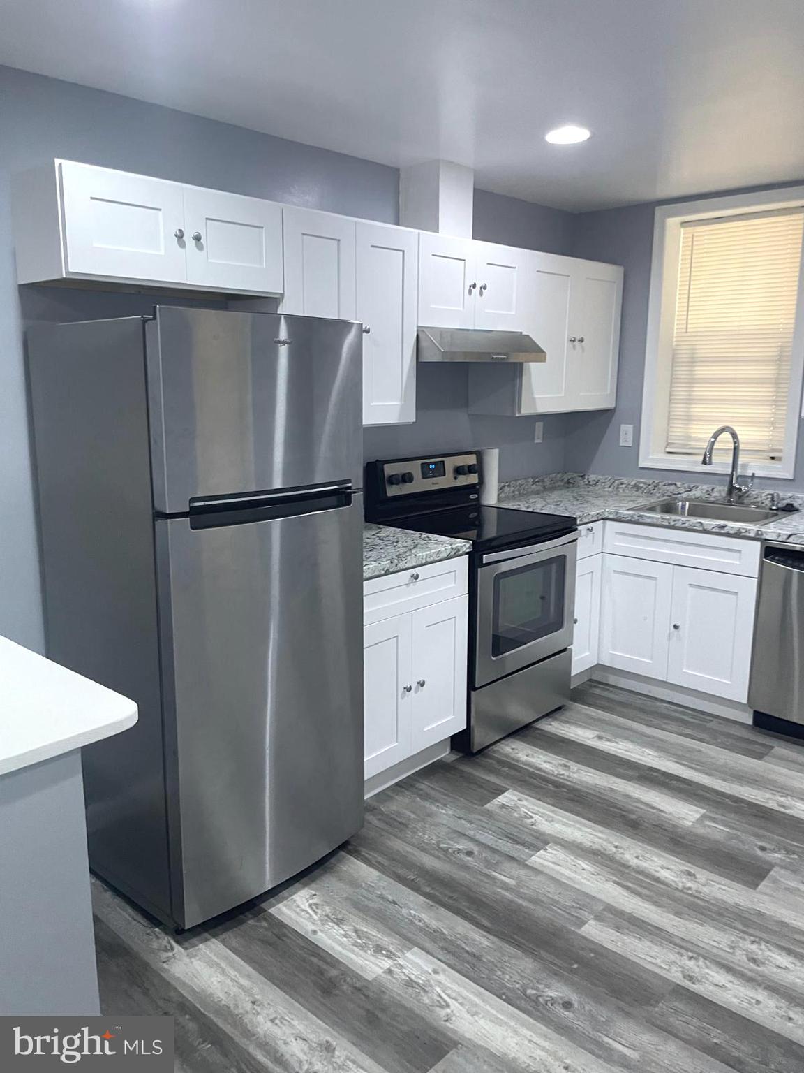 1926 North Payson Street Baltimore, MD 21217 - Photo 1 of 29 a kitchen with stainless steel appliances a refrigerator sink and cabinets