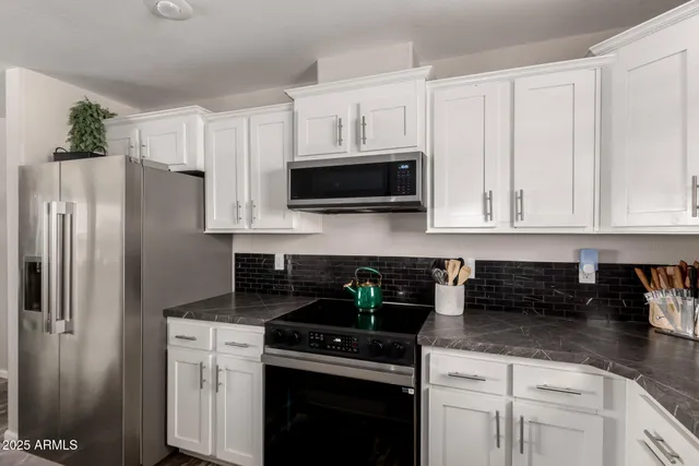 a spacious bedroom with a bed and a ceiling fan