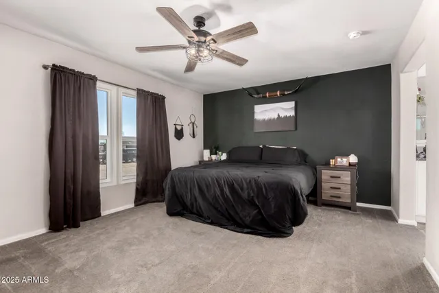 a bedroom with furniture and flat screen tv