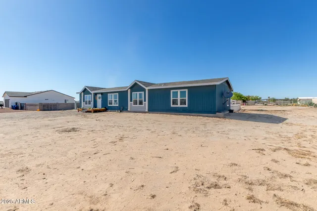 a view of house with yard and ocean