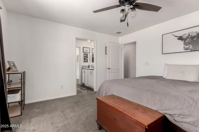 a en suite bathroom with a double vanity sink and a mirror