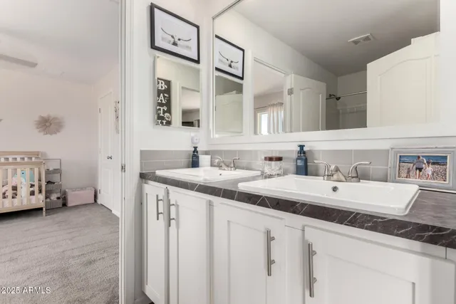 a white toilet sitting next to a bathroom sink