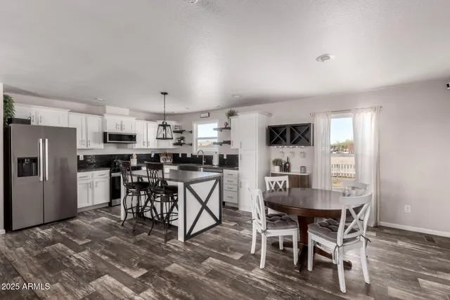 a kitchen with a sink dishwasher a stove a microwave and cabinets